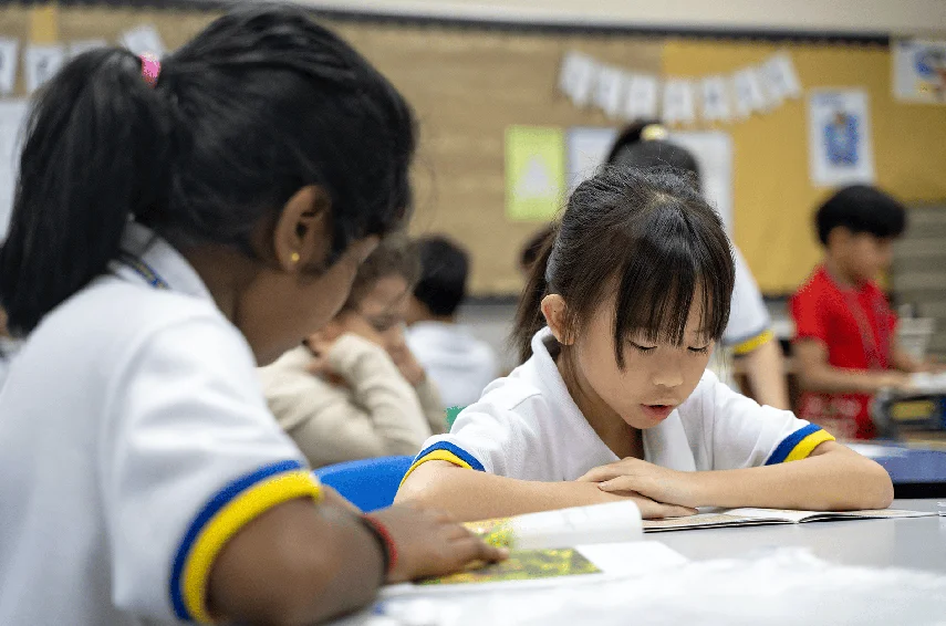 Students reading their books during a lesson