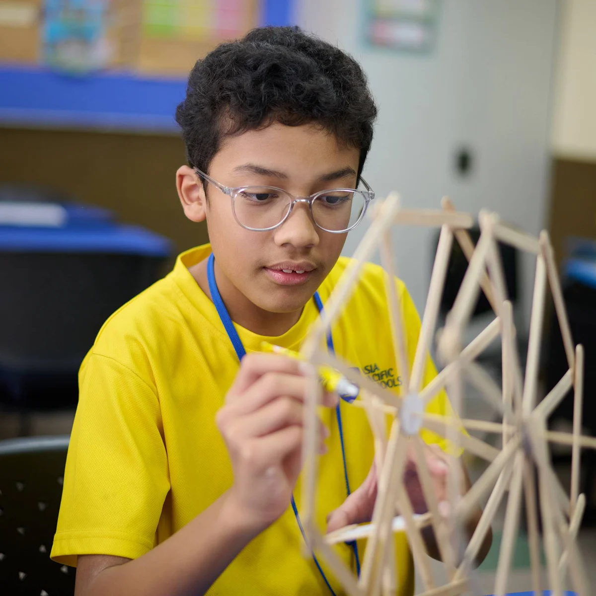 APS student building a small wooden structure