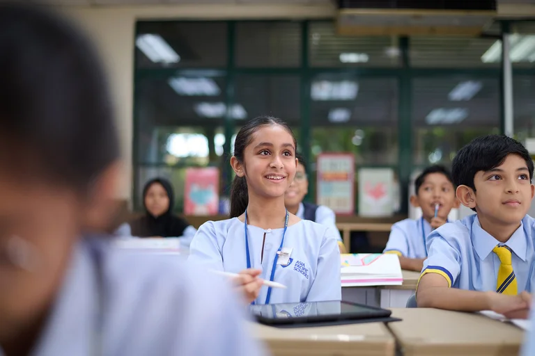 Primary school student smiling during a lesson