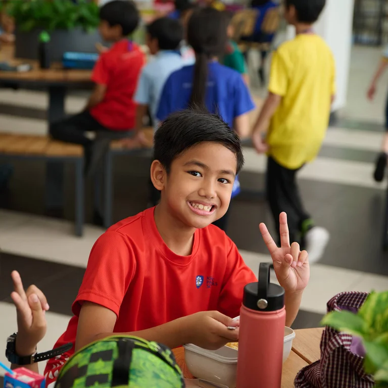 Asia Pacific School student smiling while eating