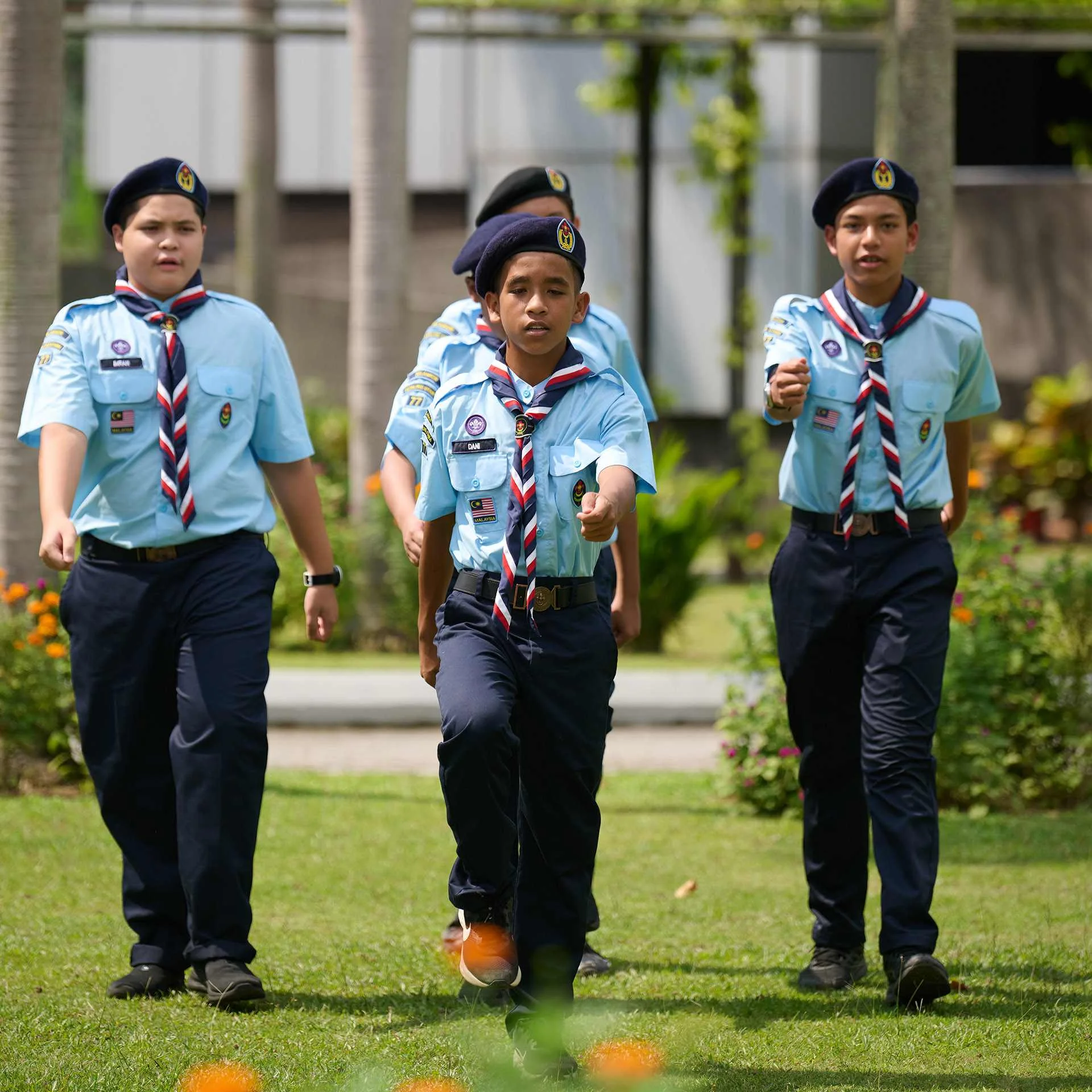 Four young students marching together