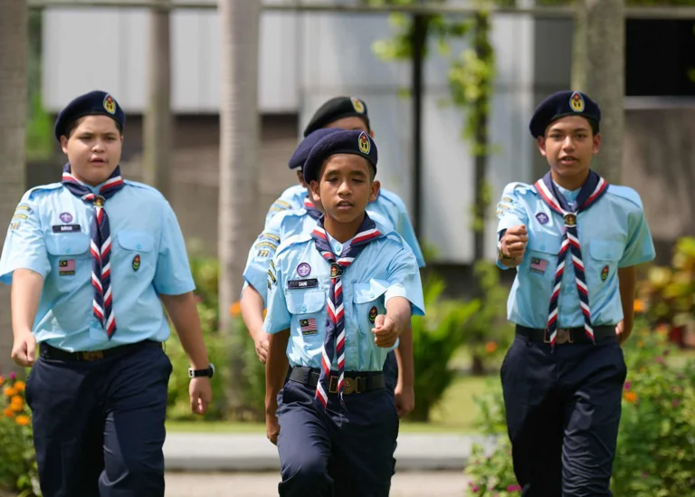 Four young students marching together