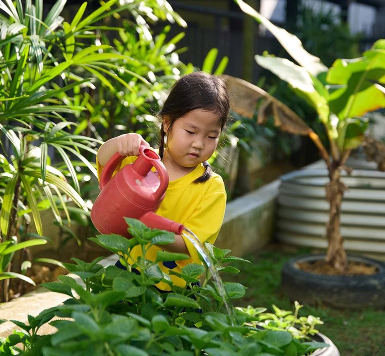 Kid watering plants