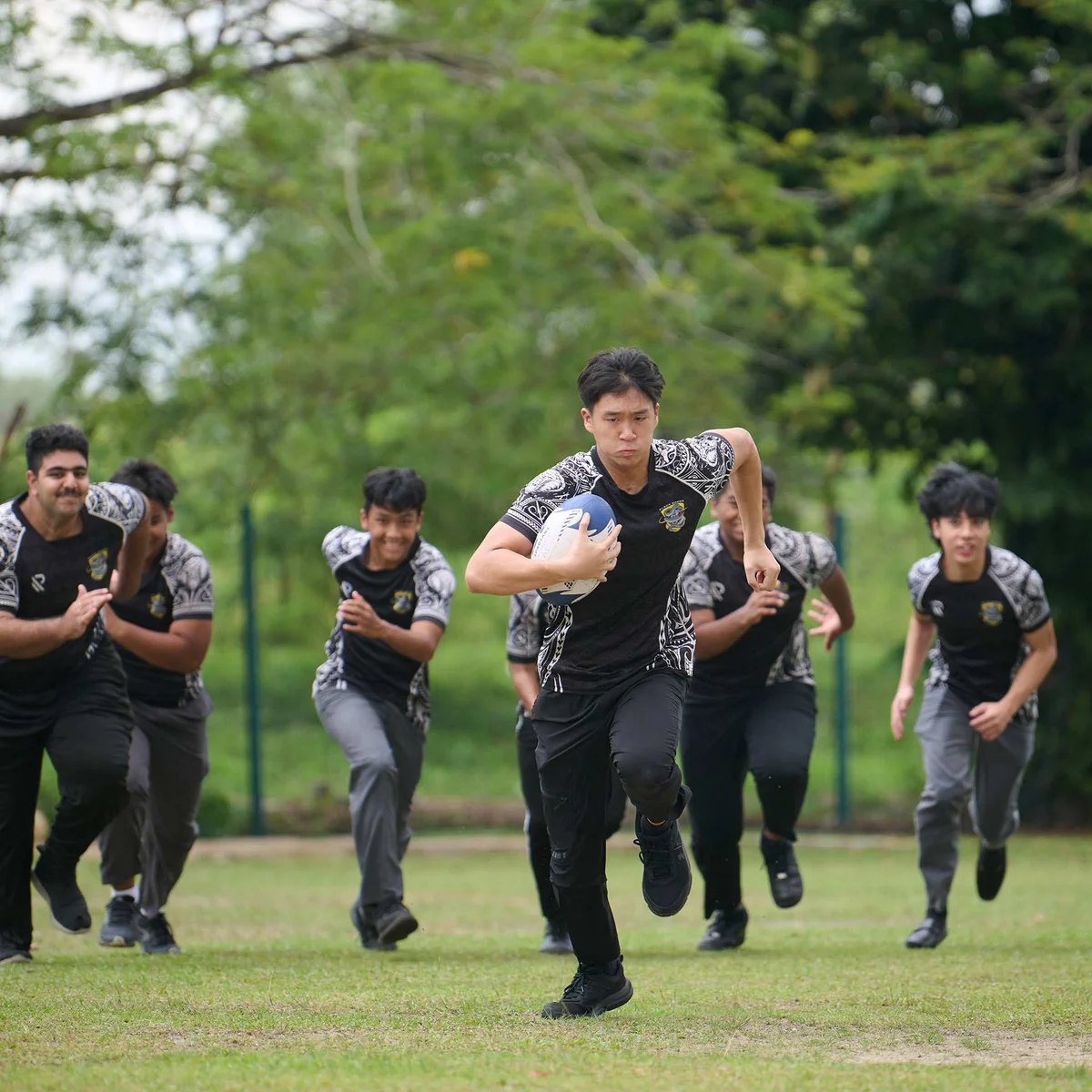 Teenagers playing rugby