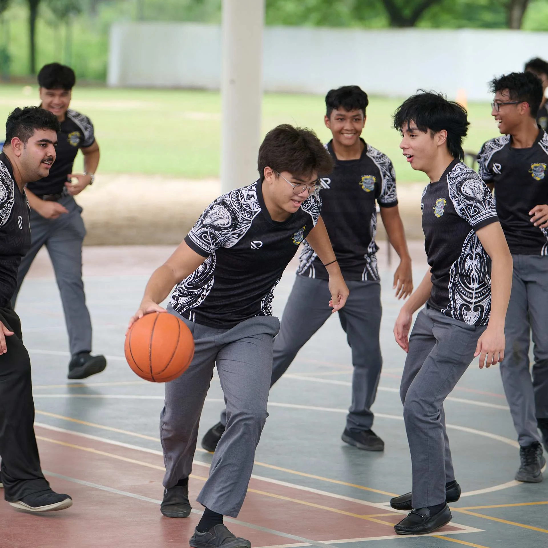 Teenagers playing basketball