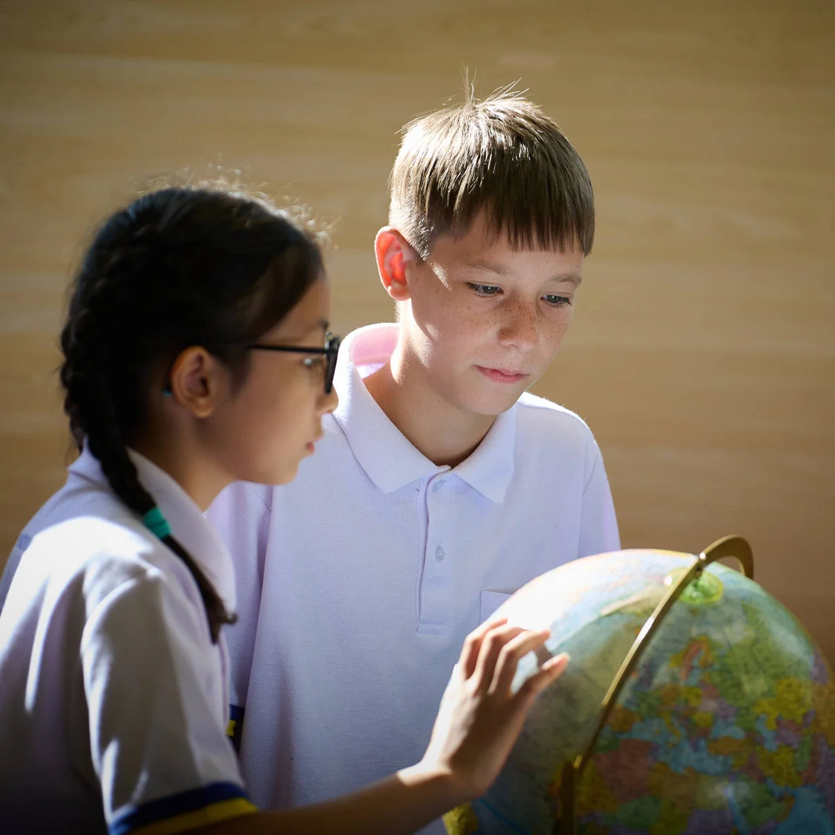 Kids looking at a globe