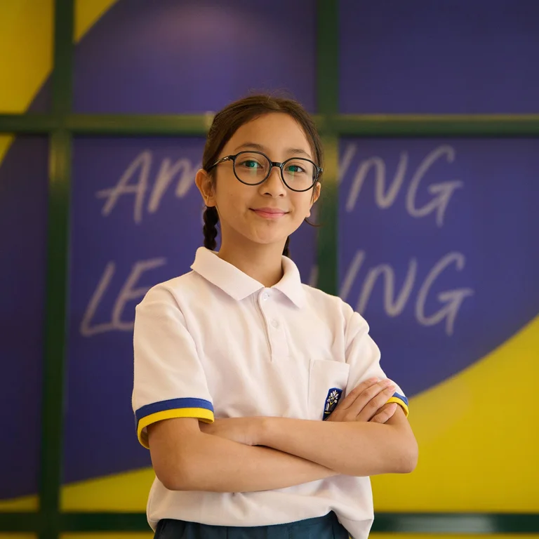 student-smiling-holding-arms